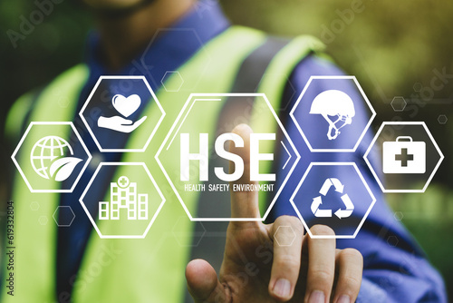 HSE - health safety environment concept.Construction inspector in uniform is checking industrial building and environment.Safe and standardized industry.