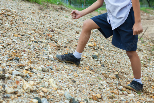 Children are walking on the gravel in the park.