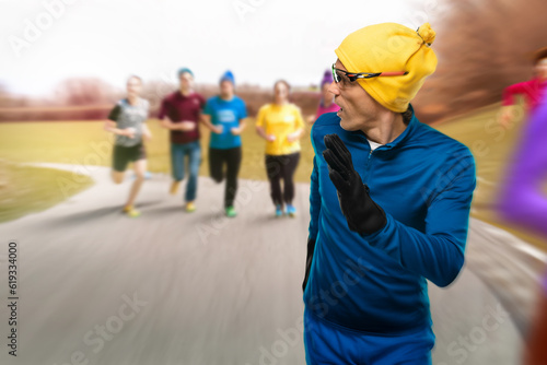 Young man amateur runner taking part in half marathon, Unseasoned young jogger engaging in a half marathon event.