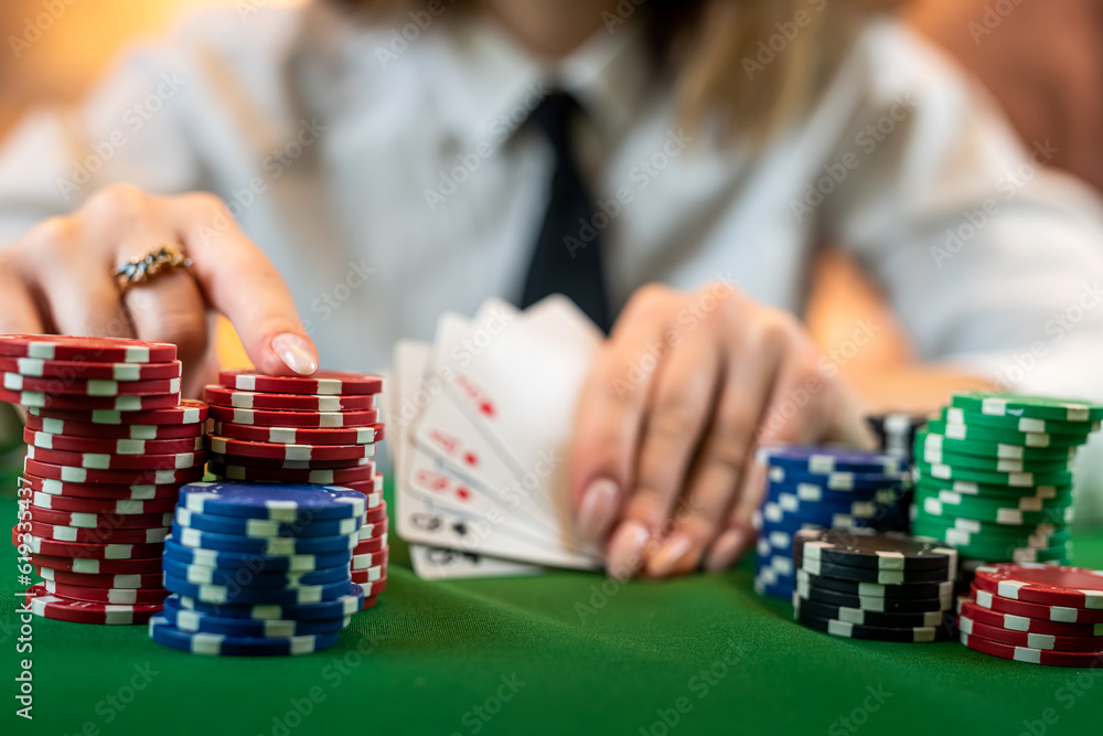 woman who knows how to play poker perfectly sits at a poker table with cards and chips. woman who knows how to play poker perfectly sits at a poker table with cards and chips.