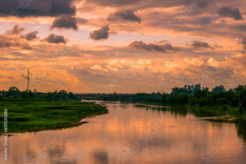Landscape of the river at sunset with a beautiful cloudy sky.