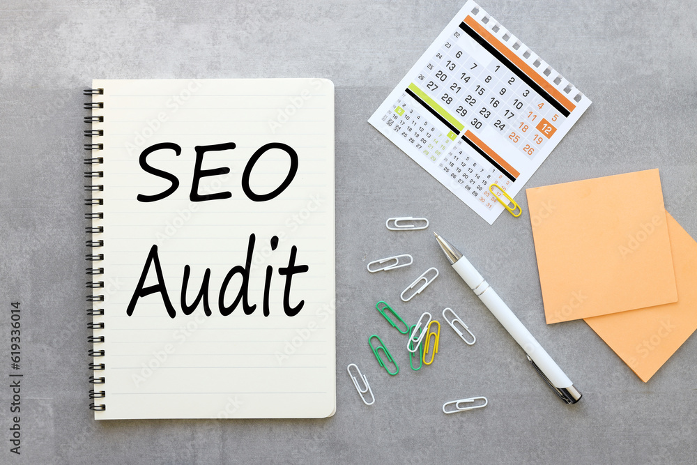 gray background with notepad and calendar .text on paper SEO AUDIT. Business concept. gray background with notepad and calendar .text on paper SEO AUDIT. Business concept.