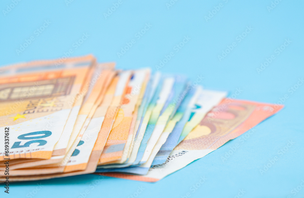 10, 20 and 50 euro bills on a blue background with copy space 10, 20 and 50 euro bills on a blue background with copy space