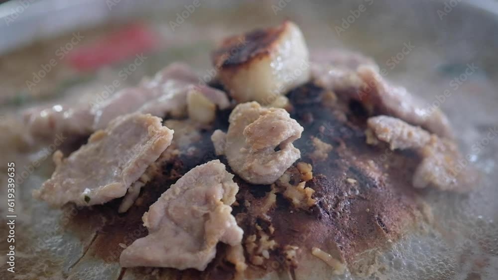 Cooking and eating Moo Kata, Thai barbecue grill pork in the outdoors. Cooking and eating Moo Kata, Thai barbecue grill pork in the outdoors.