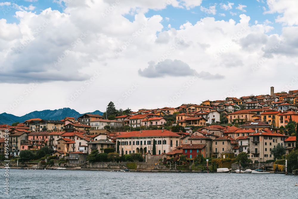 italian village on the lake with alps background. View of village on Como Lake, Milan, Italy with Alps mountains in background.