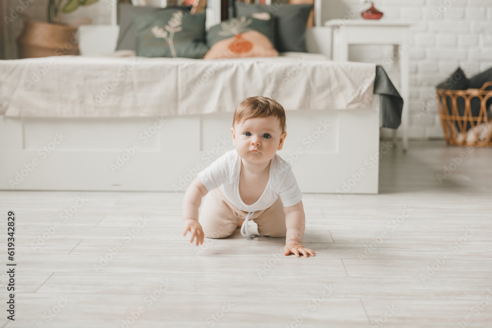 crawling baby 6 months in the nursery at home.