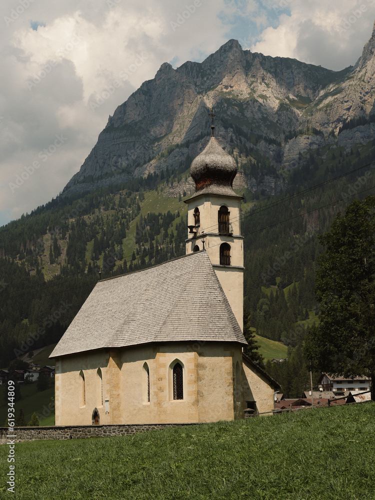 historic alpine church, isolated little church on dolomitic landscape. typical mountain religious architecture. Calm and spiritual space in nature.