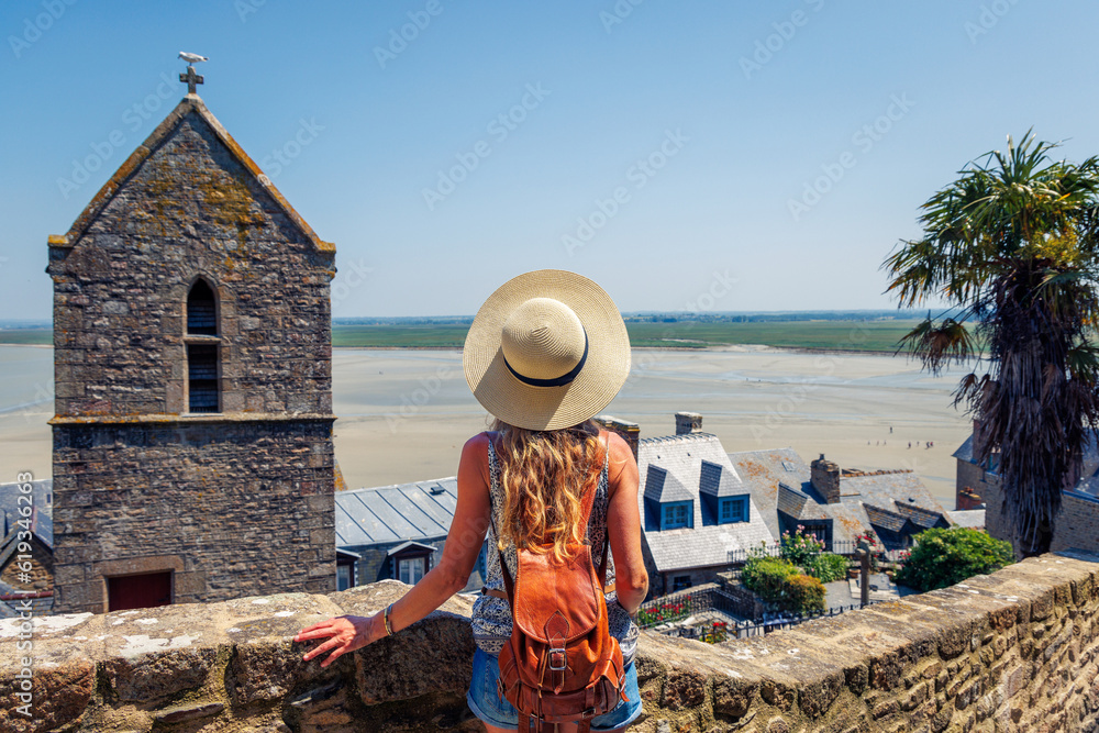 Woman tourist visiting the mont saint michel town- Normandy in France