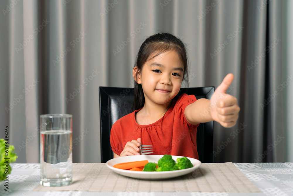 Cute little girl showing thumb showing eating healthy vegetables. Cute little girl showing thumb showing eating healthy vegetables.