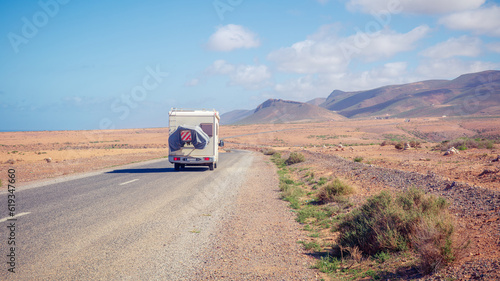 road trip in motorhome in desert landscape- travel destination, adventure, wanderlust concept