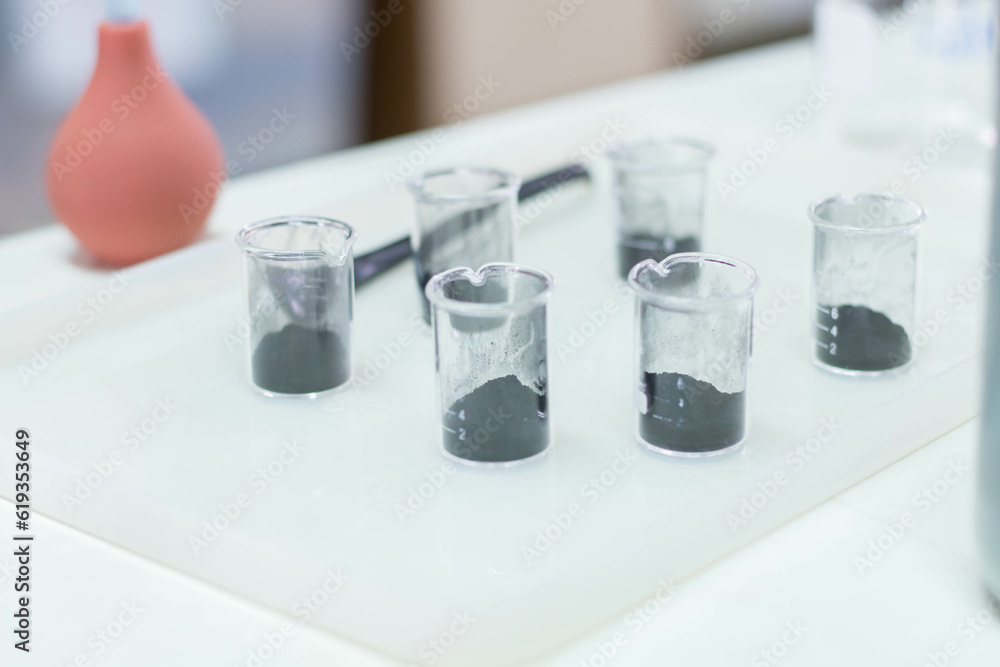 Laboratory glassware filled with black liquid, science laboratory research and development concept Laboratory glassware filled with black liquid, science laboratory research and development concept