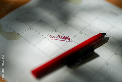 close up of a calendar and pen