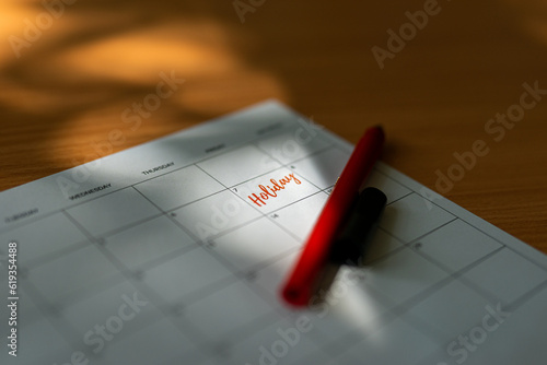 close up of a calendar and pen