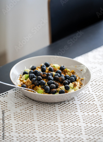 breakfast bowl with greek yoghurt, blueberries, granola and a diced apple, healthy fitness food breakfast