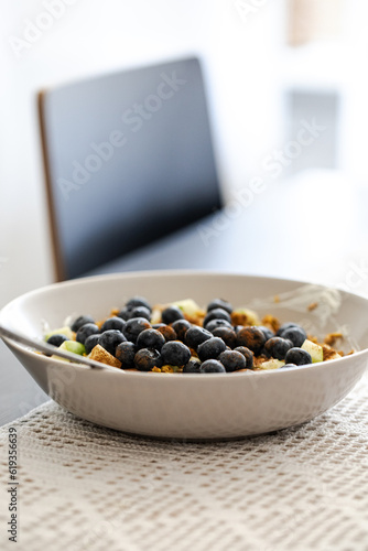breakfast bowl with greek yoghurt, blueberries, granola and a diced apple, healthy fitness food breakfast