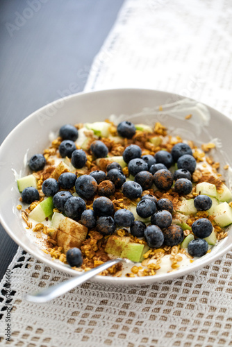breakfast bowl with greek yoghurt, blueberries, granola and a diced apple, healthy fitness food breakfast