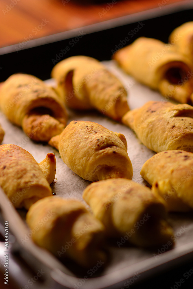 Just out of the oven, freshly baked mini croissants with a crispy crust.
