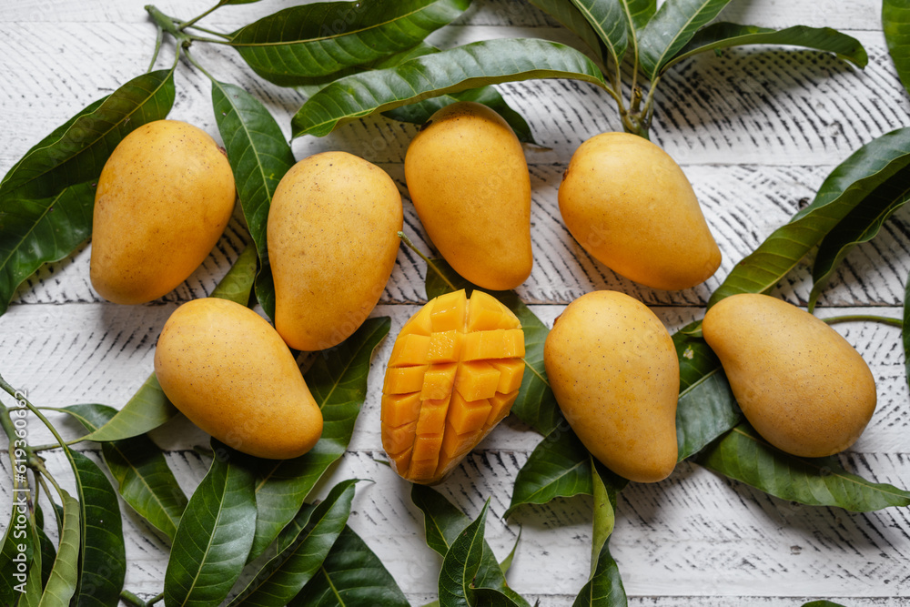 Ripe mangoes on white wood