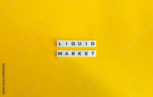 Liquid Market Phrase on Letter Tiles on Yellow Background. Minimal Aesthetic.