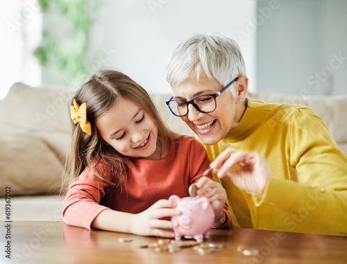 Fotografía child money saving grandfmother family coin senior finance bank piggybank happy