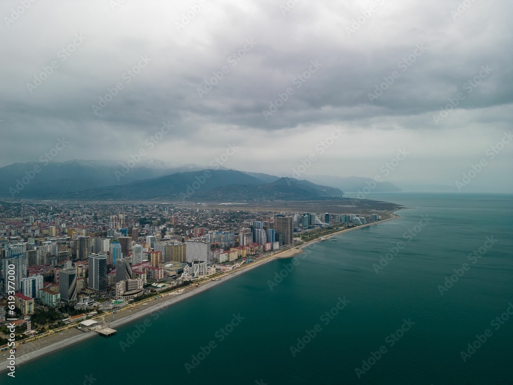 Aerial shot of the coastal town against a clouded sky