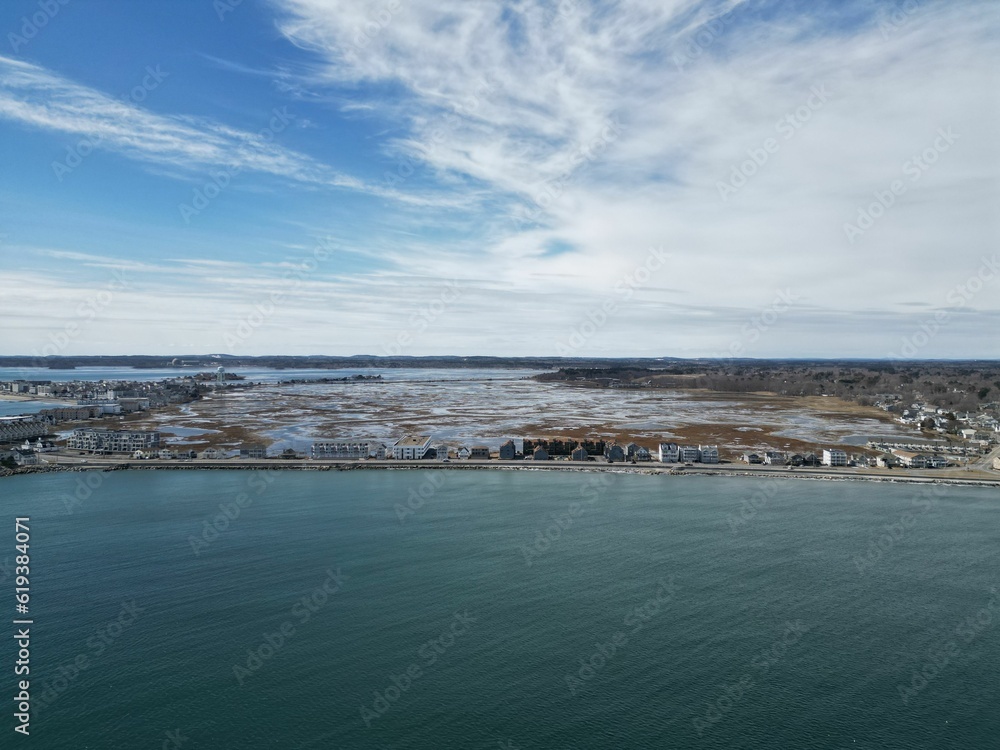 Beautiful seascape featuring a body of water situated next to a pristine sandy Hampton beach Beautiful seascape featuring a body of water situated next to a pristine sandy Hampton beach