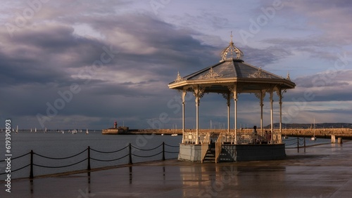 Scenic view of an old traditional alcove on a pier against the sea on a cloudy day