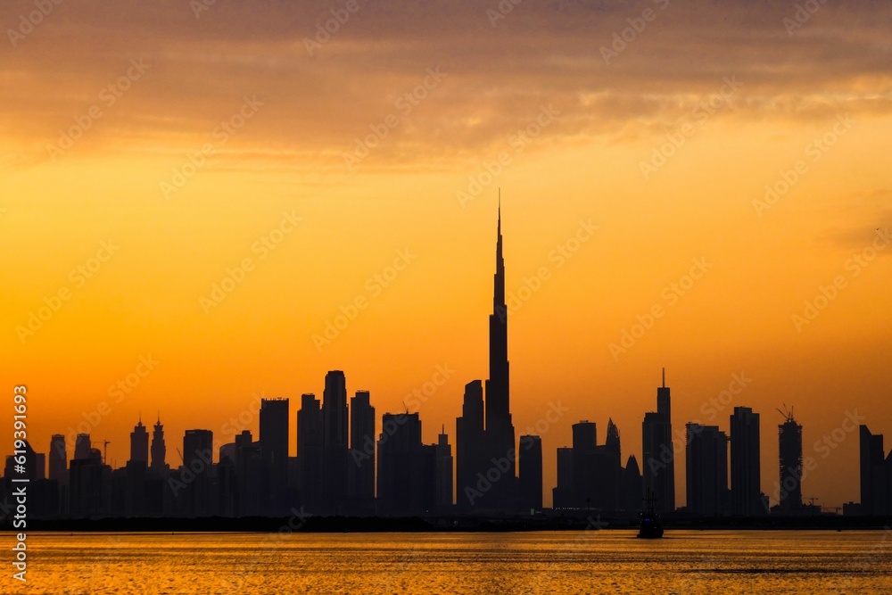 Silhouette view of the skyline of Dubai city against beautiful sunset sky