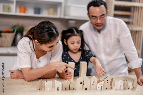 Parents teach values to their daughter and develop efficient habits via hardwood toys to save for future housing. Guided and inspired learning and supportive encouragement to build lifelong character