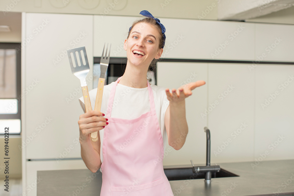 smiling happily and offering or showing a concept. Barbecue tools concept smiling happily and offering or showing a concept. Barbecue tools concept