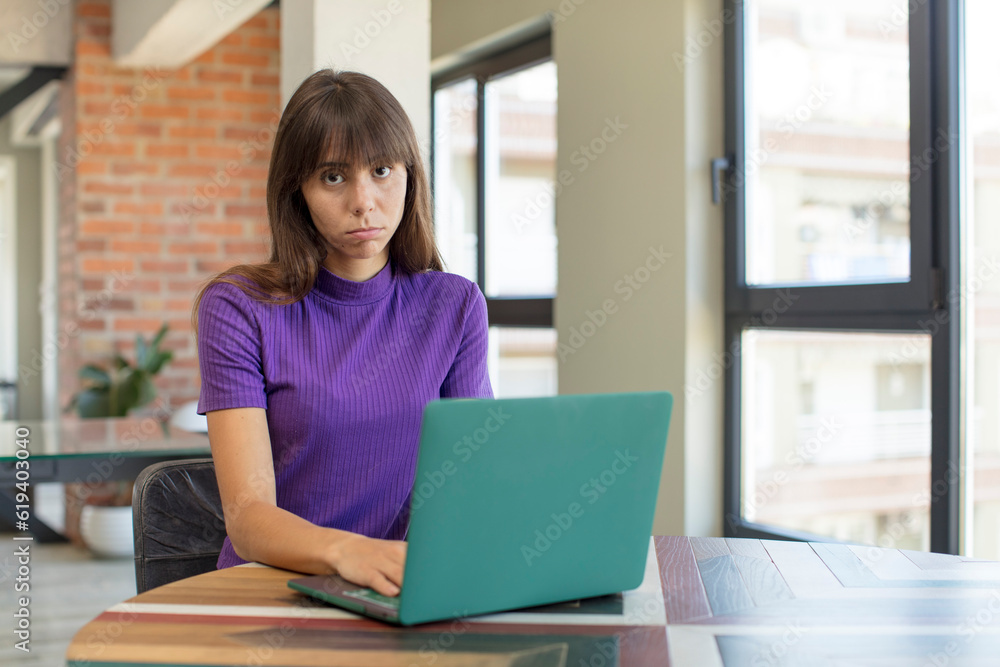 young pretty woman feeling sad and whiney with an unhappy look and crying. desk laptop concept young pretty woman feeling sad and whiney with an unhappy look and crying. desk laptop concept