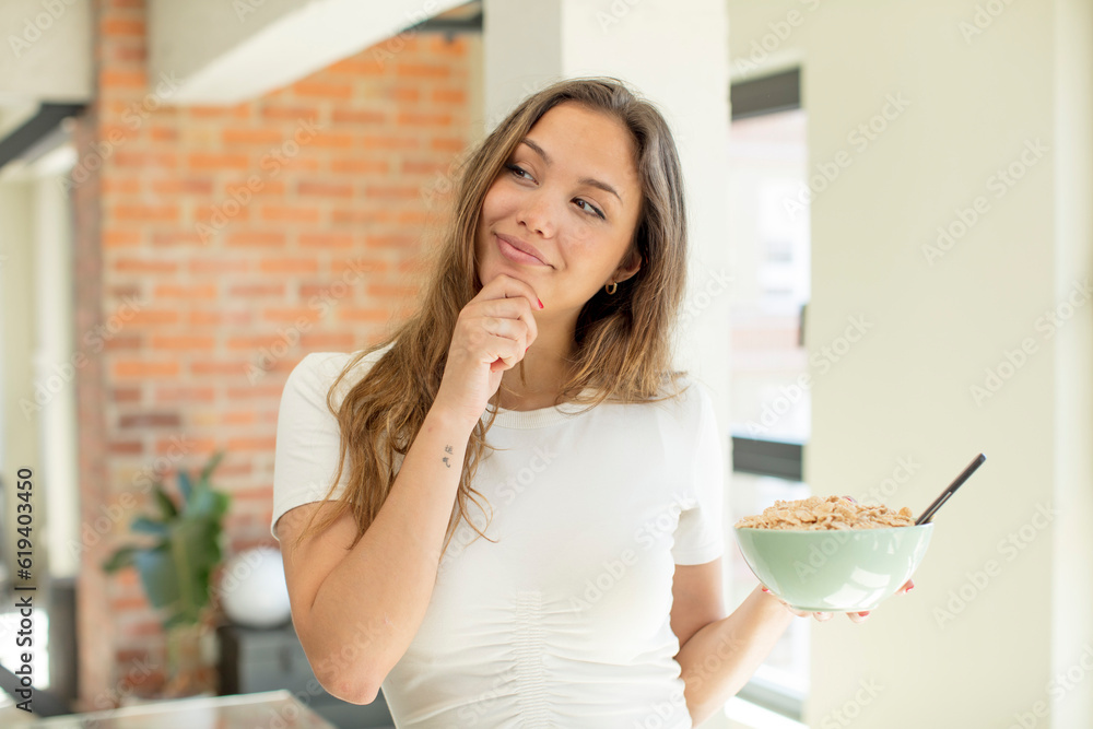 pretty woman smiling with a happy, confident expression with hand on chin. breakfast bowl concept pretty woman smiling with a happy, confident expression with hand on chin. breakfast bowl concept