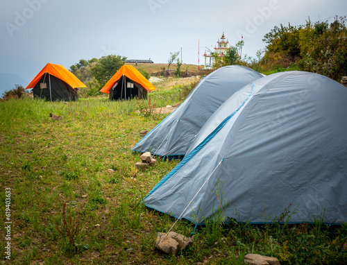 Camps with orange outer fly on a Camp Ground. Nag Tibba  Himalayan region of Uttarakhand. Trekking And Camping