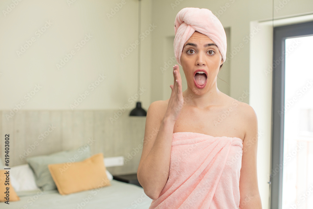 pretty young model feeling extremely shocked and surprised. bathrobe concept pretty young model feeling extremely shocked and surprised. bathrobe concept