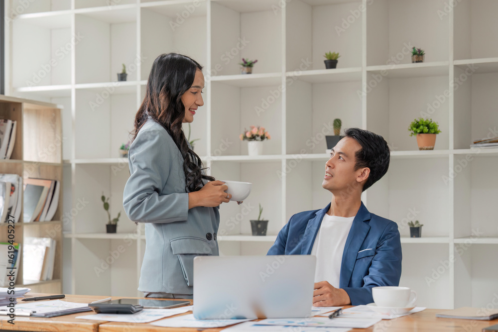 Two business people talk project strategy at office meeting room. Businessman discuss project planning with colleague at workplace while having conversation and advice on financial data report