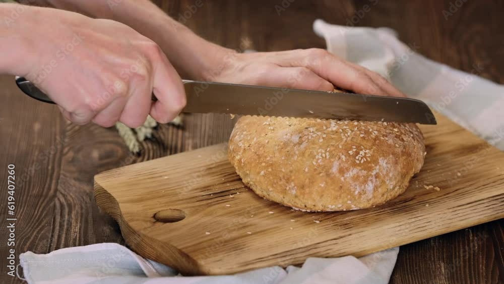 Cutting fresh homemade yeast-free bread Cutting fresh homemade yeast-free bread