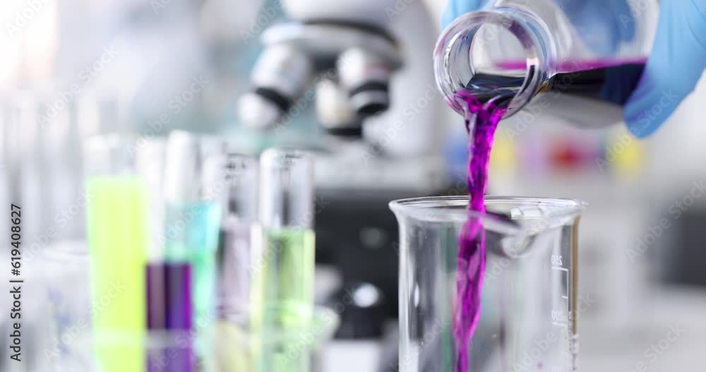 Chemist pouring pink liquid into flask in laboratory 4k movie. Pharmaceutical business concept Chemist pouring pink liquid into flask in laboratory 4k movie. Pharmaceutical business concept