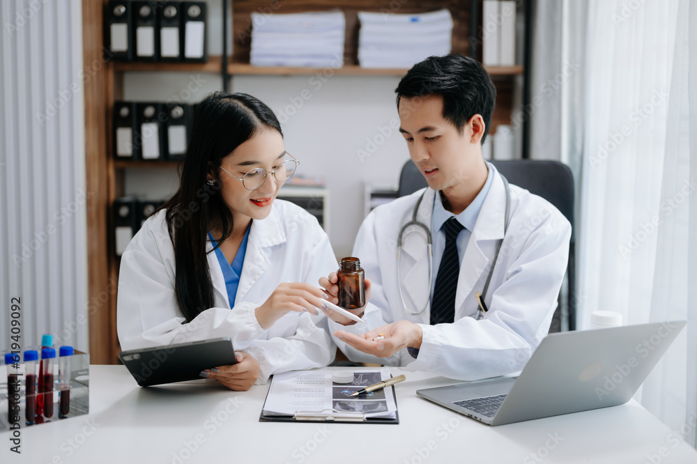 Medical technology network team meeting concept. Asian Doctor hand working with smart phone modern digital tablet and laptop computer with graphics chart interface, Medical technology network team meeting concept. Asian Doctor hand working with smart phone modern digital tablet and laptop computer with graphics chart interface,