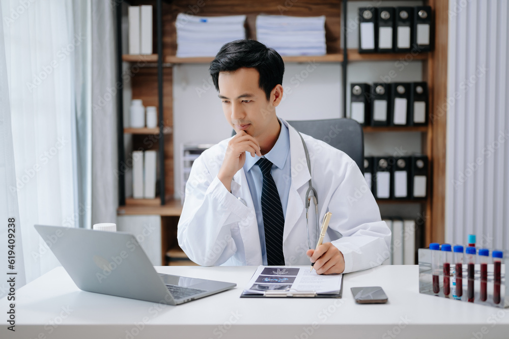 Medical technology concept. Asian Doctor working with mobile phone and stethoscope in modern office Medical technology concept. Asian Doctor working with mobile phone and stethoscope in modern office