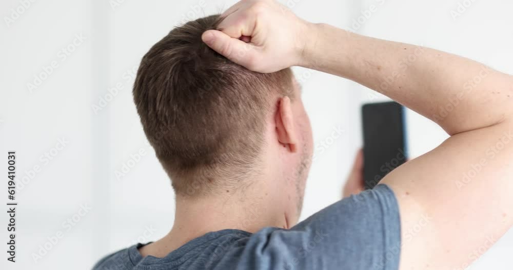 Young man holding mobile phone and shouting 4k movie. Negative human emotion concept Young man holding mobile phone and shouting 4k movie. Negative human emotion concept