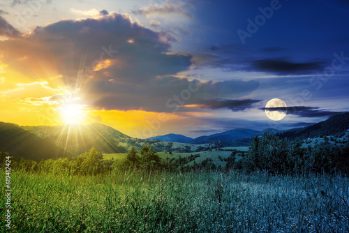 day and night time change concept. Alpine meadow with tall grass on a background of mountains with sun and moon at twilight