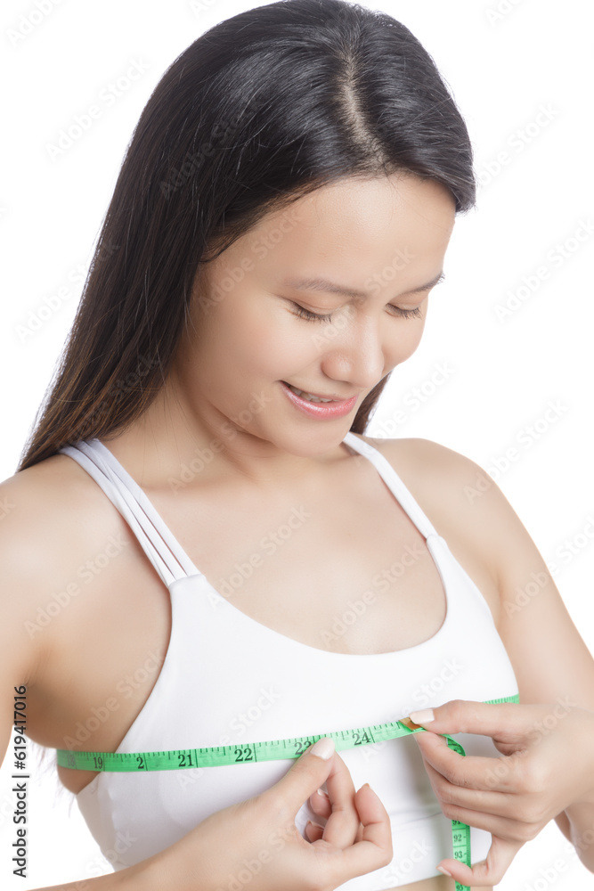 Beautiful young Asian woman measuring her chest Beautiful young Asian woman measuring her chest