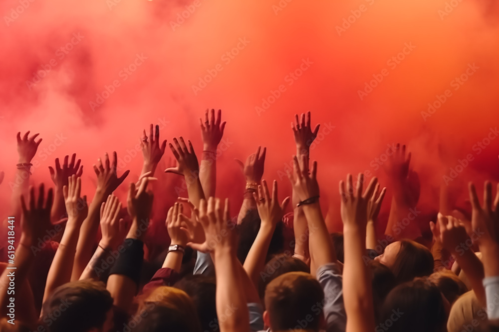 people raising hands in the concert
