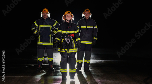 A group of professional firefighters marching through night on a rescue mission, their determined strides and fearless expressions reflecting their unwavering bravery and unwavering commitment to