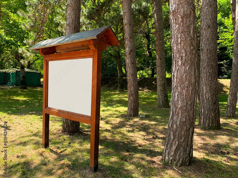 Empty white signboard in the forest, ready for text. Signboard with turn Empty white signboard in the forest, ready for text. Signboard with turn