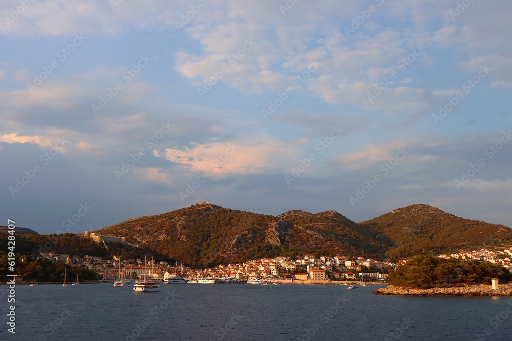 Small picturesque town Hvar on island Hvar, Croatia, illuminated by warm sunset light.