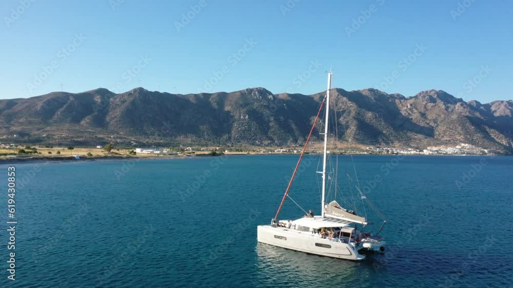 Drone shot, sightseeing flight around sailboat on turquoise sea, Dodecanese, Greece, Europe Drone shot, sightseeing flight around sailboat on turquoise sea, Dodecanese, Greece, Europe