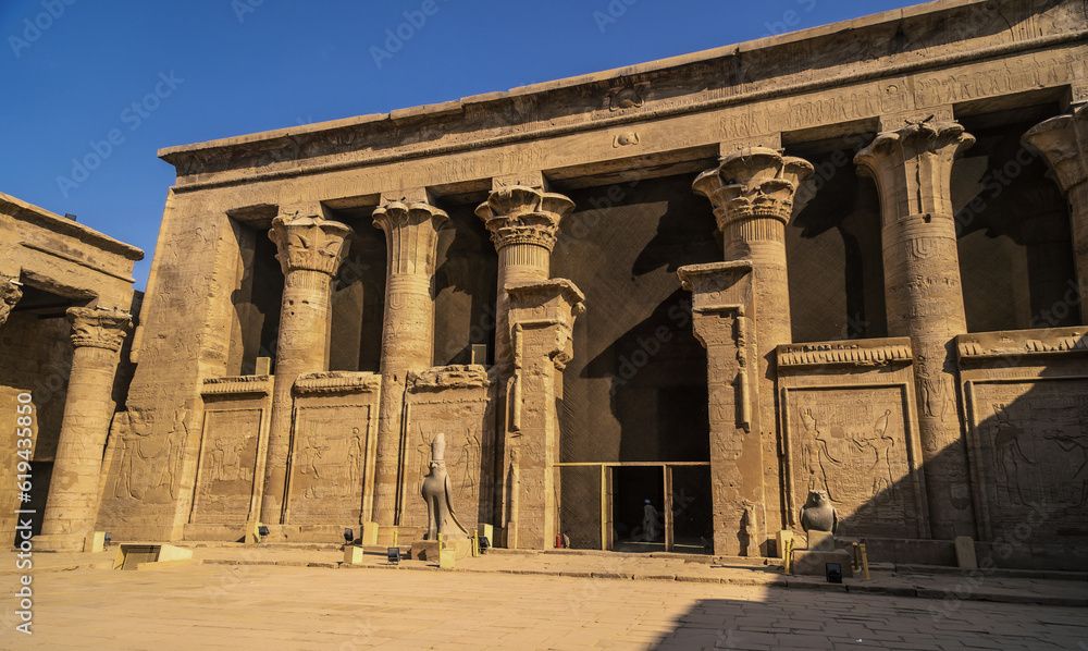 Facade with drawing of pharaohs of the Temple of Edfu in the city of Edfu, Egypt. On the bank of the Nile river, geco-Roman construction, temple dedicated to Huros