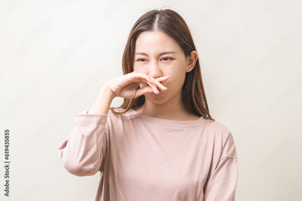 Bad smelling, deodorant asian young woman hand squeeze, covering nose smell stink, breathing smelly disgust strong, expression face dislike odor, smelly armpit underarm. Medical health, skin body care Bad smelling, deodorant asian young woman hand squeeze, covering nose smell stink, breathing smelly disgust strong, expression face dislike odor, smelly armpit underarm. Medical health, skin body care