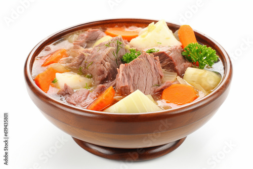 a bowl of meat and potato soup on a white background